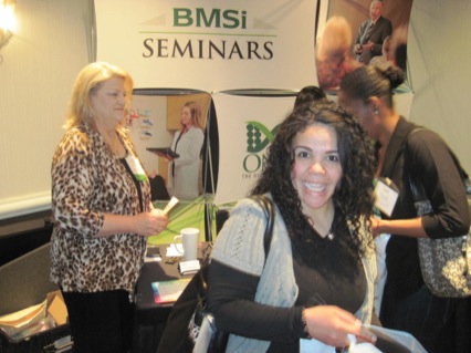Attendees visit Carol Gravlee at the BMSi booth