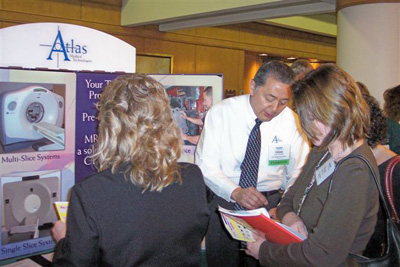 Glenn Tokushige (center), Atlas Medical Technologies, with SATRO attendees