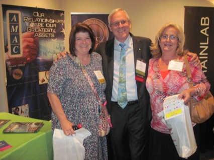 Attendees visit James Hugh at the AMAC booth