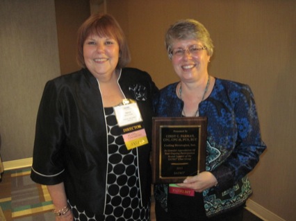 Director Marcia Phillips gives Cindy Parman the annual chat room support award